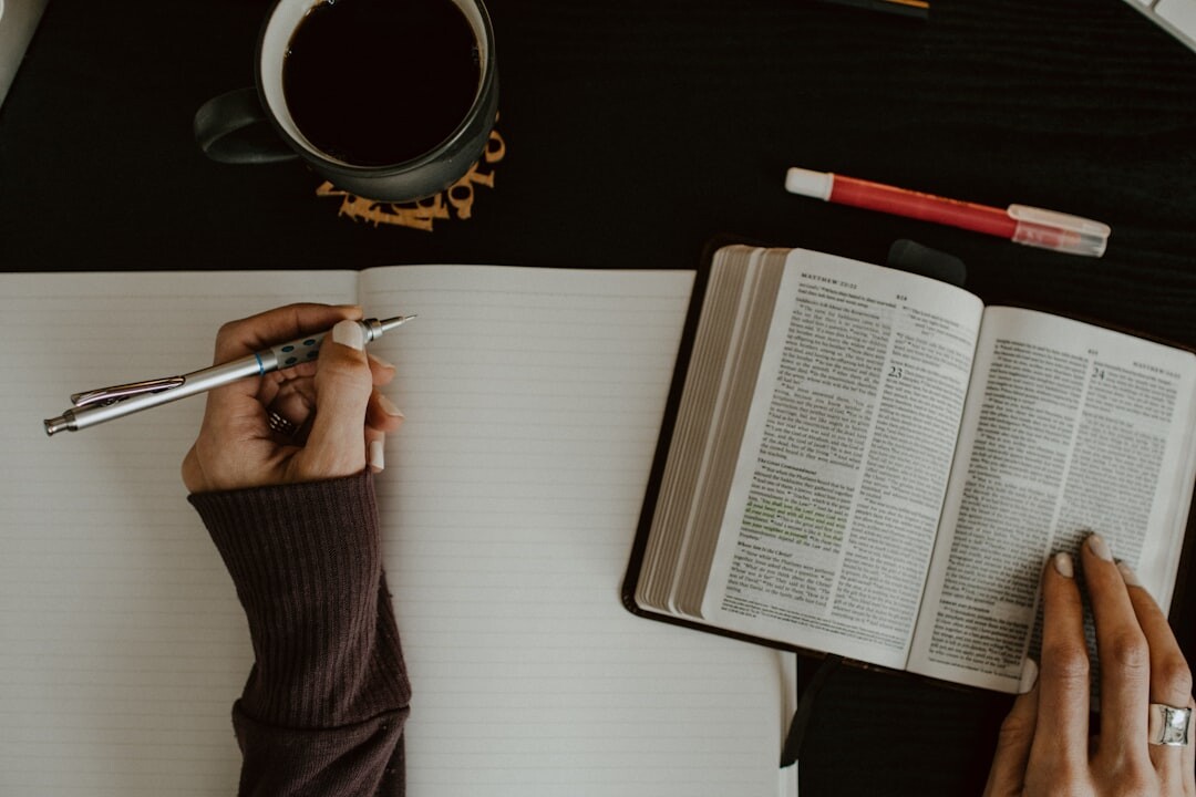 person writing in journal