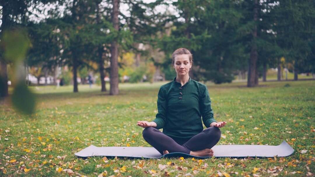person meditating in nature