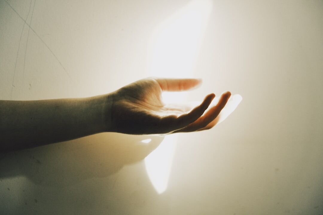 person reaching for light