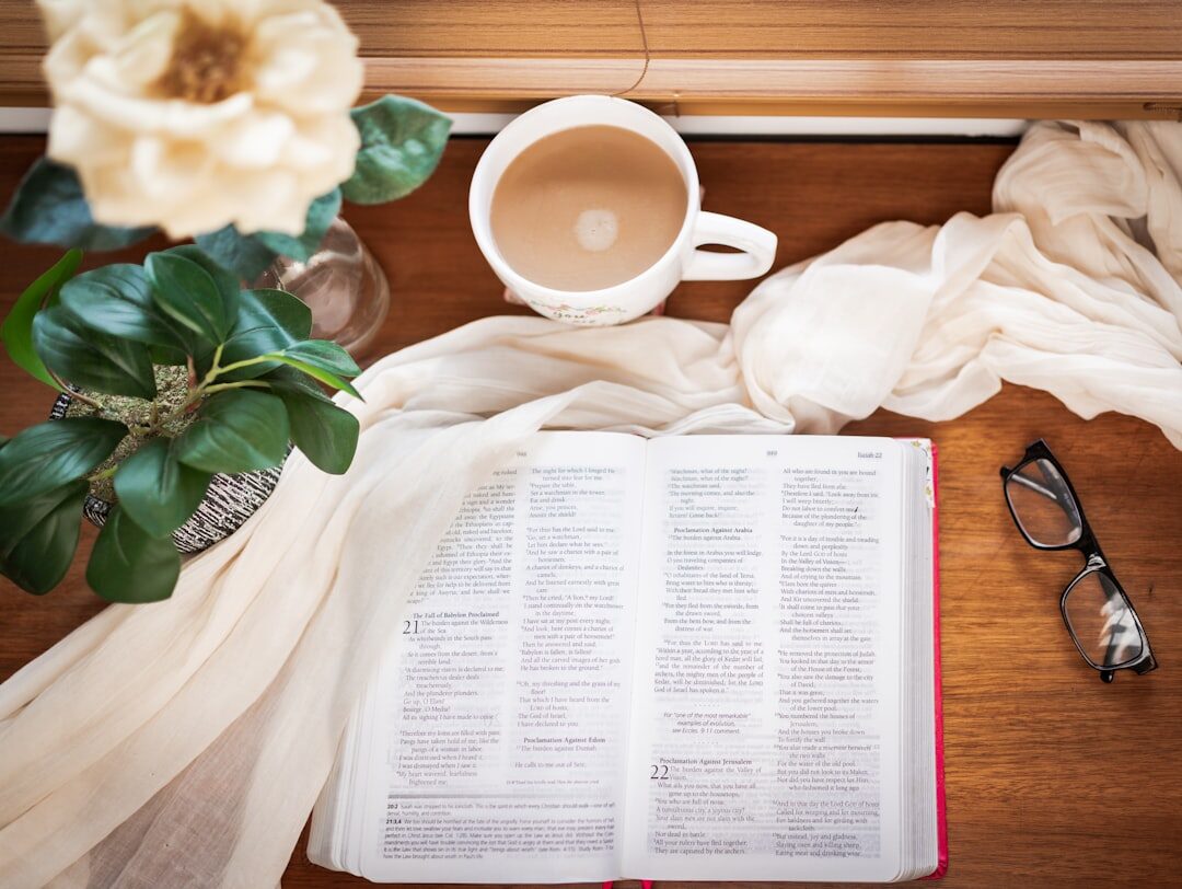 Open journal notebook with pen and cup of coffee on a wooden desk